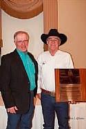  Les Timmons (left) presenting CCHA Hall of Fame plaque to Glen Brown of Oakbank, MB